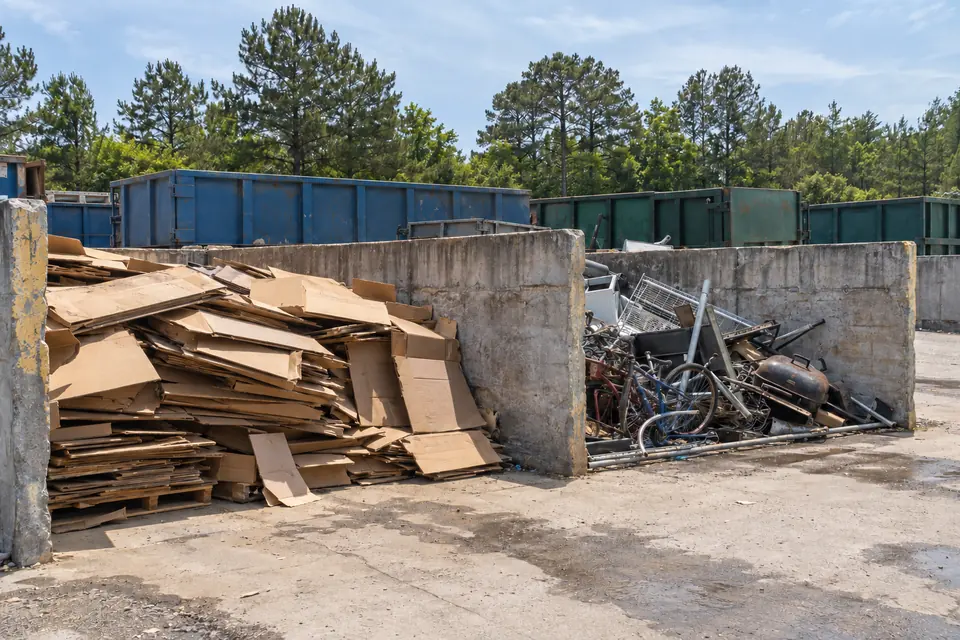 Cardboard and scrap metal sorted into bays at a recycling center